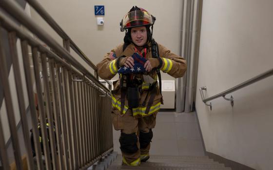 Photo Of U.S. Air Force Tech. Sgt. David Kehl, 8th Civil Engineer Squadron fire officer, leads the 9/11 Remembrance stair climb at Kunsan Air Base, Republic of Korea, Sept. 11, 2024. Participants wore lanyards with the names and photos of first responders who died on 9/11 as they climbed a total of 2,200 steps of the dorm to signify the 110 stories of the World Trade Center..