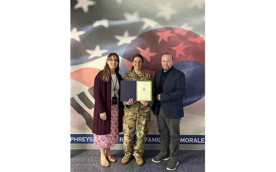 Stars and Stripes Commander Lt. Col. Marci Hoffman presents best MWR/FSS/MCCS award to USAG Humphreys MWR staff.