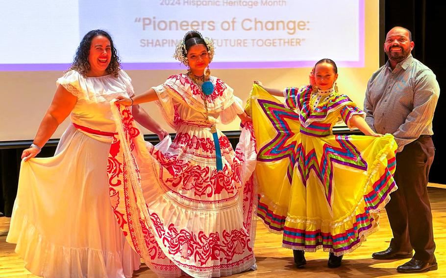 Humphreys Middle School Assistant Principal Ms. Natalya Cho and Administrative Officer Mr. Michael Robinson with 7th grade student Mia Ruiz representing Panama and 5th grade student Camilia Barroso representing Mexico.