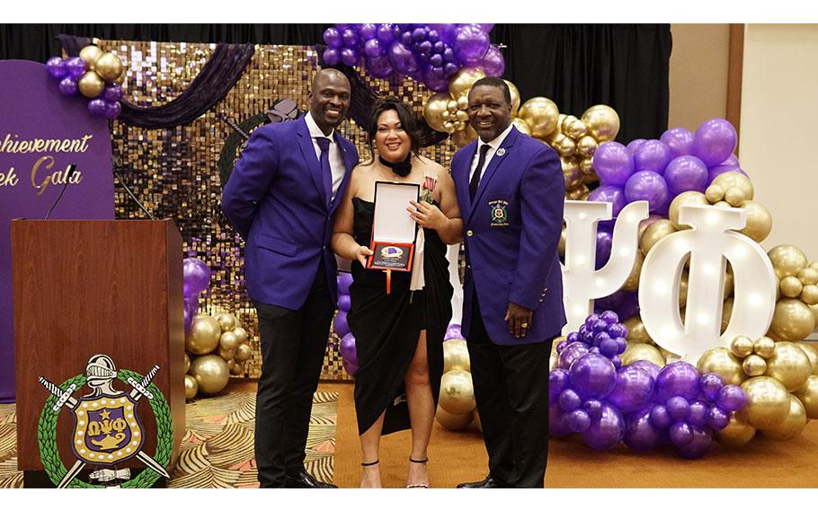 Ms. Aiana Janica G. Artis received a special award from the Brothers of Lambda Xi Chapter (Event Coordinator Mr. Eugene Gibbs and Past Immediate Basileus Mr. Rodney Brown) for set up all of the beautiful decorations at the Achievement Week Banquet held on Camp Humphreys Army Base.  
