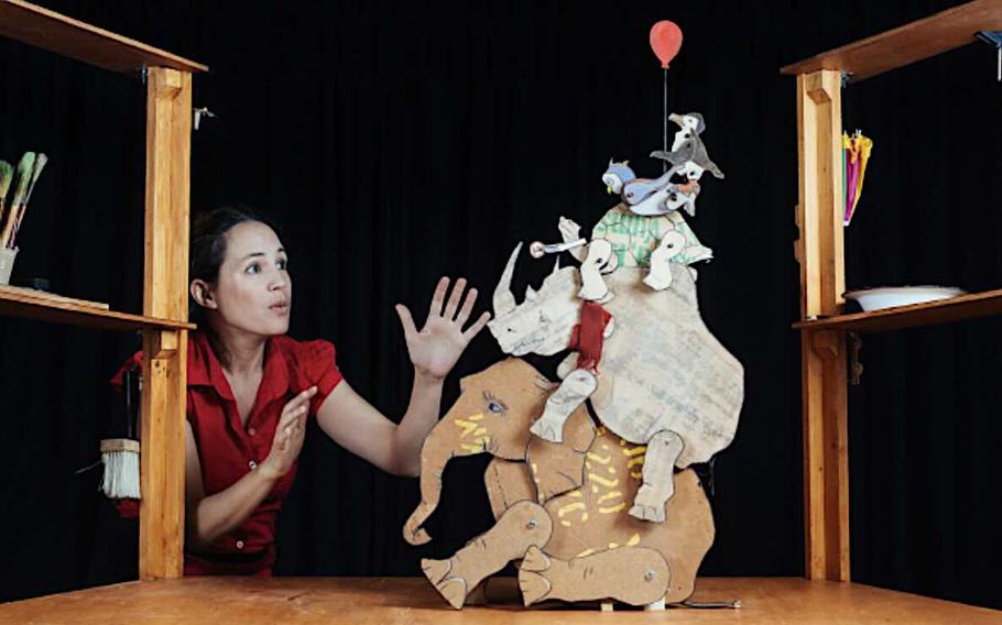 a woman acrting in a puppet show.