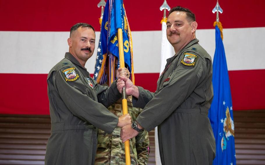 U.S. Air Force Lt. Col. Michael Ryan, incoming 5th Reconnaissance Squadron commander, right, accepts the squadron guidon from Col. Geoffrey Cameron, 9th Operations Group commander, during a Change of Command ceremony at Osan Air Base, Republic of Korea, June 11, 2025. Prior to taking command, Ryan served as the 9th Reconnaissance Wing chief of safety at Beale Air Force Base, California. 