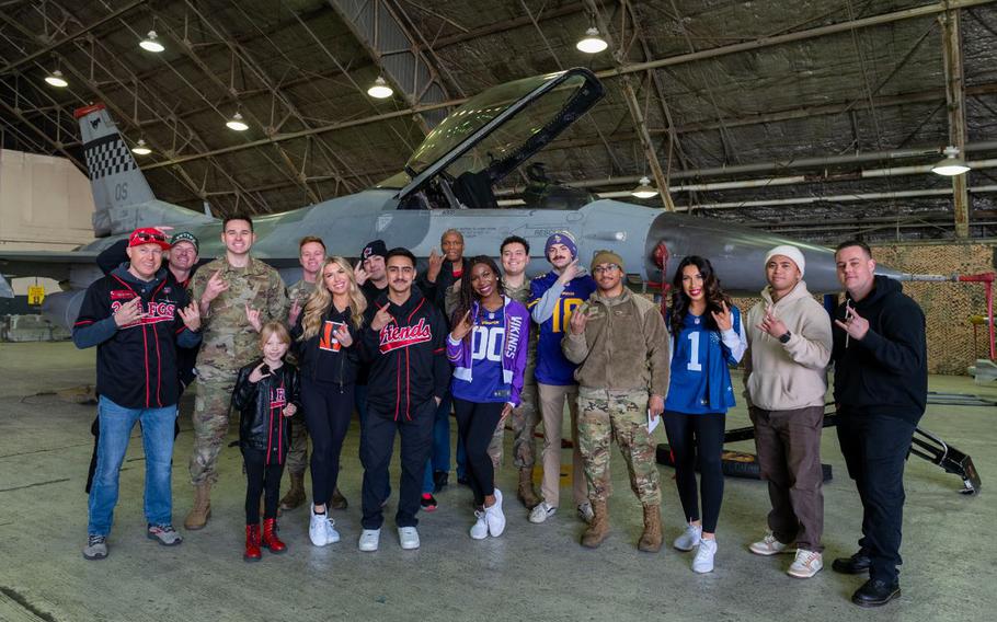 U.S. Airmen assigned to the 36th Fighter Generation Squadron and their family members take a group photo with NFL cheerleaders during the Pro Blitz 2024 unit visit at Osan Air Base, Republic of Korea, Feb. 10, 2024. NFL players, cheerleaders and mascots visited more than 200 military bases in five regions across the globe as part of Armed Forces Entertainment’s Pro Blitz Tour.
