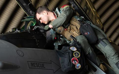 Photo Of U.S. Air Force Capt. Chris Newman, 36th Fighter Squadron F-16 Fighting Falcon pilot, inspects the cockpit of his aircraft.