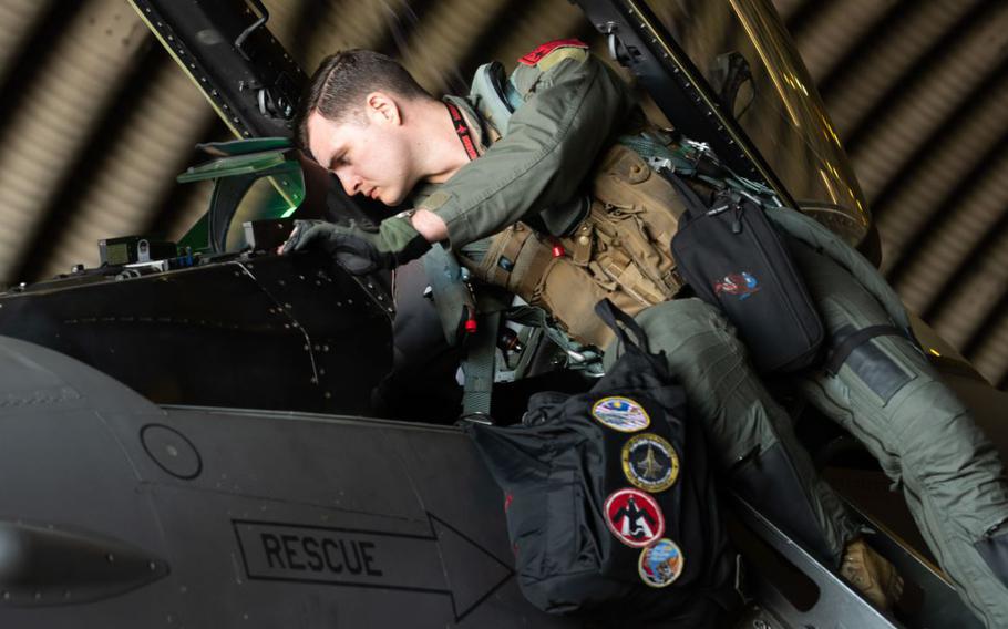 U.S. Air Force Capt. Chris Newman, 36th Fighter Squadron F-16 Fighting Falcon pilot, inspects the cockpit of his aircraft.
