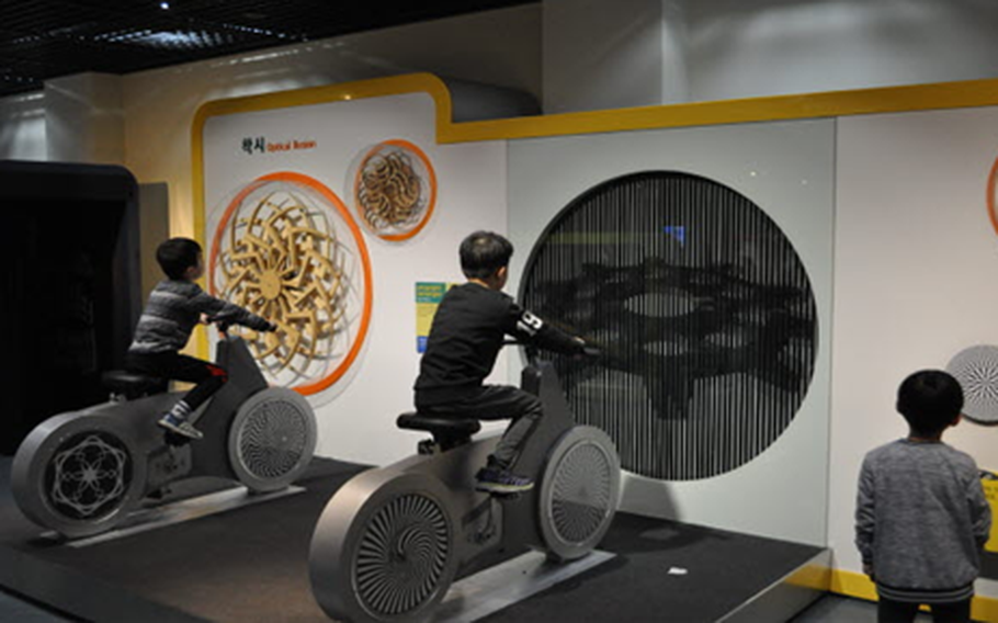 kids are enjoying an exhibition in which bicycles are used.