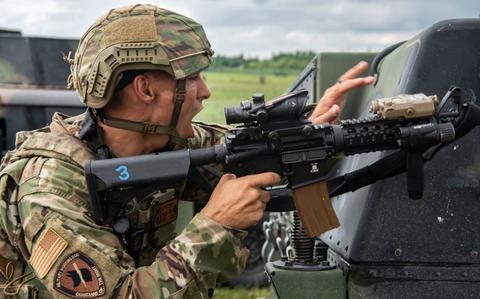 Photo Of U.S. Air Force Staff Sgt. Dylan White yells to the driver of a Humvee to advance.