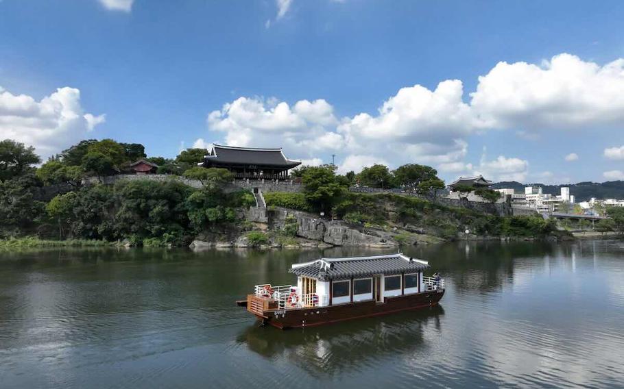 a cruise is sailing across the river.