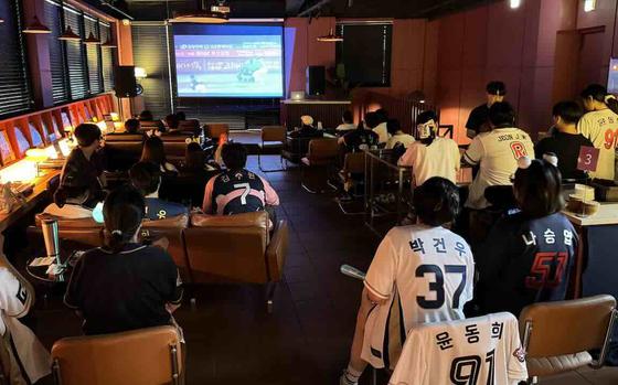 Customers are watching a baseball game in Jinju Brewery.