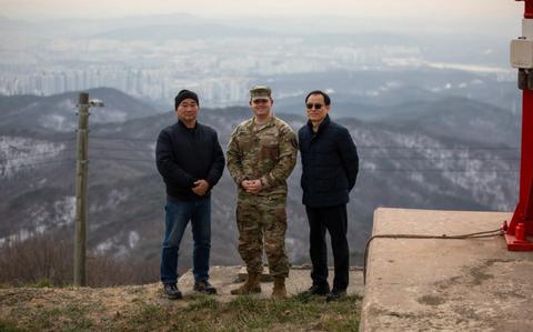 Photo Of three people pose at the Top Site of Camp Madison.