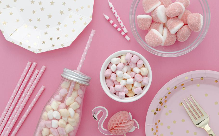 marshmallows and some other snacks are on the table.