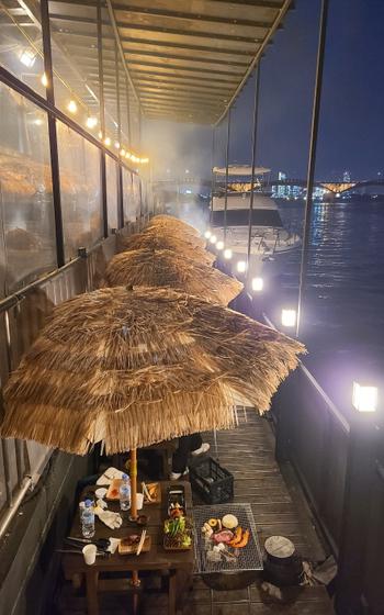 BBQ on a boat with a view of the river