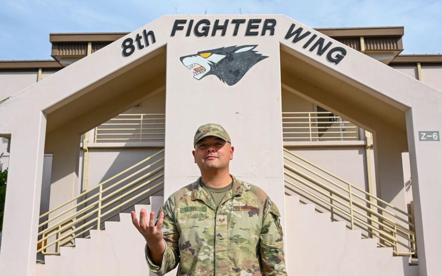 U.S. Air Force Staff Sgt. Robin Ho, 8th Operations Support Squadron intelligence supervisor, poses with the Wizard’s hand sign at Kunsan Air Base, Republic of Korea, Oct. 2, 2024. Ho was selected as the 8th Fighter Wing’s ‘Pride of the Pack’ for the week of September 30-October 4.