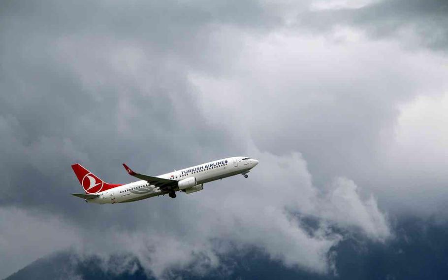 turkish airline’s air plaine is flying in the cloudy sky.