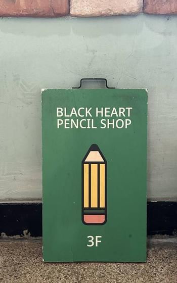 a sign at the front entrance of the shop.