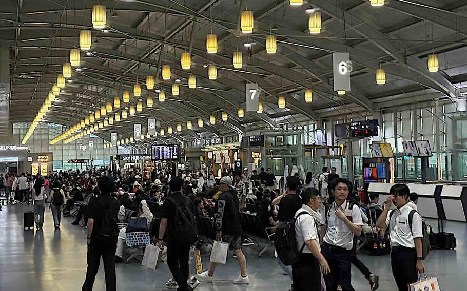 People wait for their flights in the Gimhae International Airport.