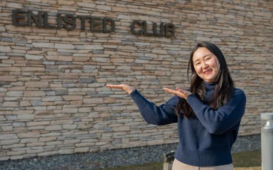 Photo Of Ms. Chong, Chu Hyon poses for a photo outside the enlisted club at Osan Air Base.