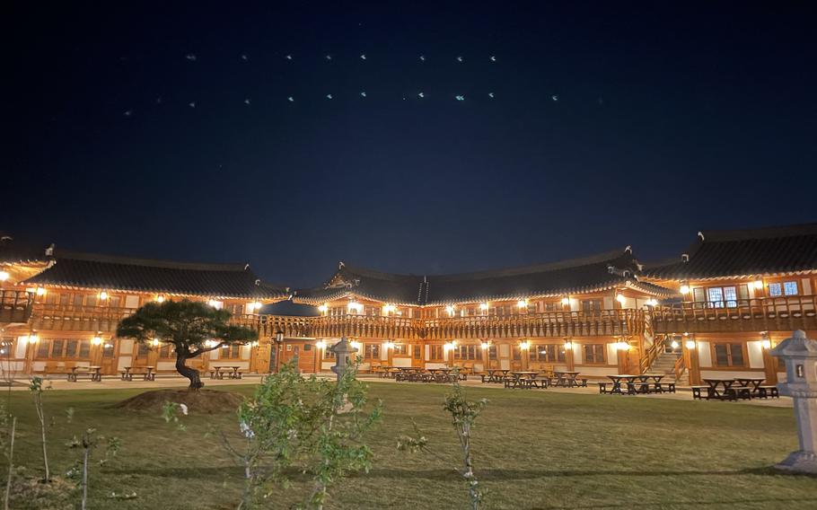 the hotel and its garden can be seen.