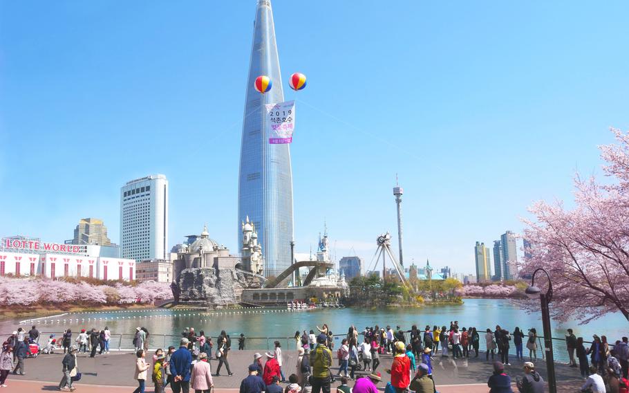 Seoul, South Korea - April 8, 2019: Lotte World Tower at Seokchon Lake park and cherry blossom festival in spring, Seoul, South Korea.