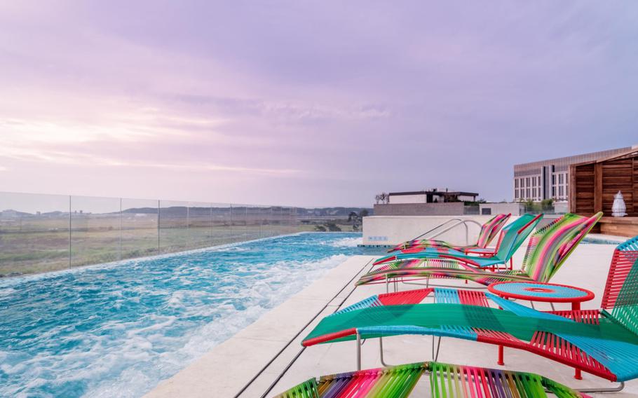 some chairs can be seen beside the outdoor pool.