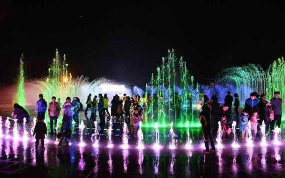 People enjoy the fountains at Dadaepo Sunset Fountain of Dreams.