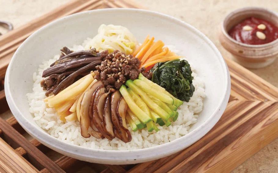 Jeonju Bibimbap and dressing for it are on the table.