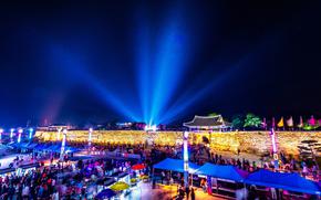 Many visitors enjoy the illuminated wall at night.