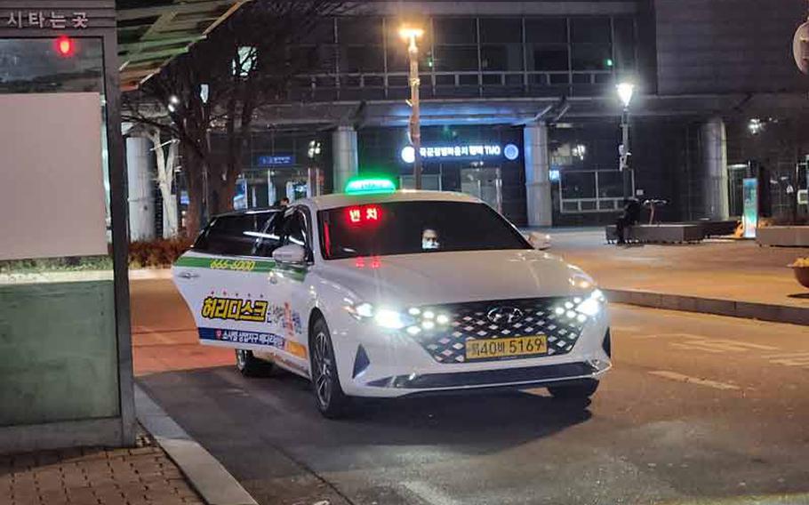 One of the taxi’s doors is open.