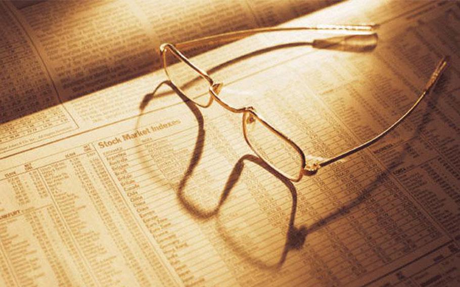 a pair of glasses on the newspaper.
