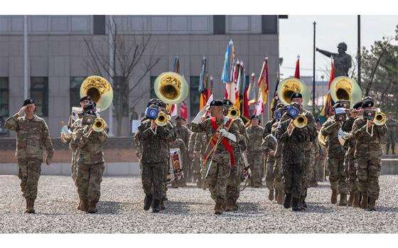 U.S. Army Soldiers assigned to the Eighth Army Band conduct pass and review.