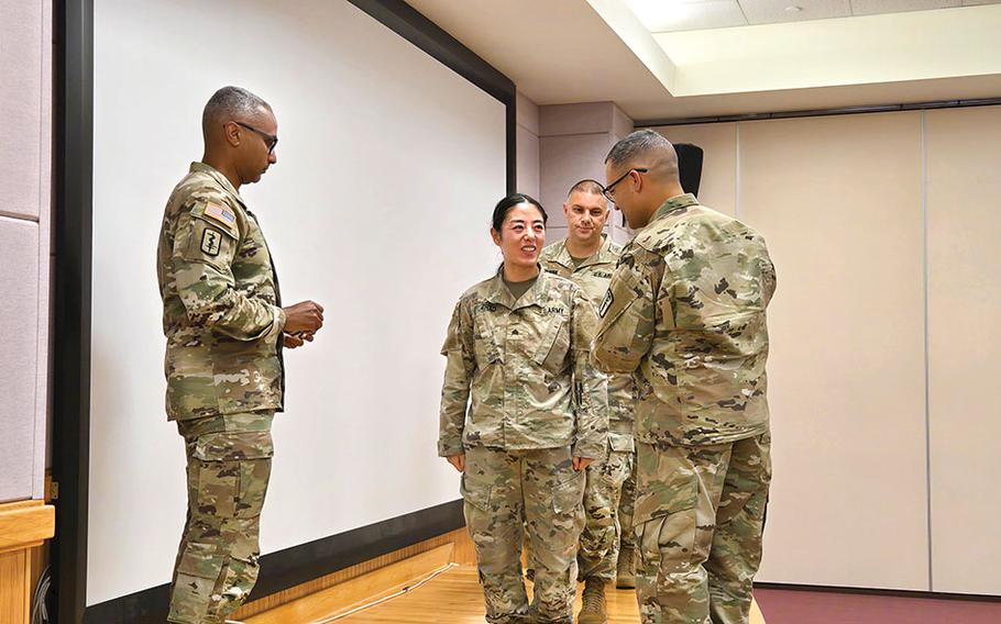 Military personnel participates in a patch ceremony.