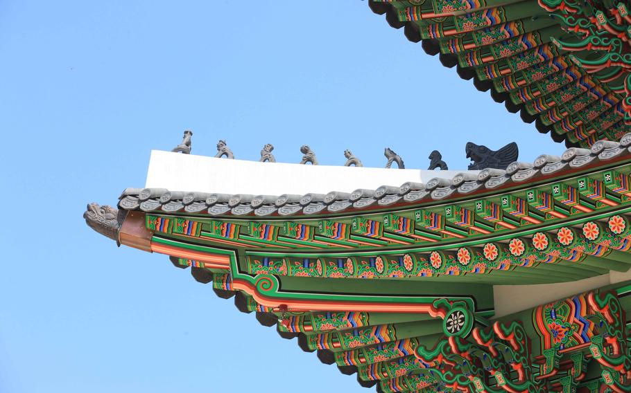 small animal figurines lined up on the rooftops.