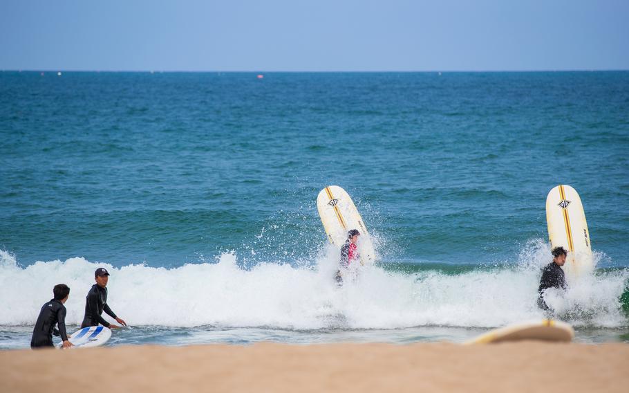 Surfers are enjoying the beach.