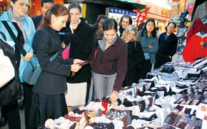 People enjoy shopping in a street festa.