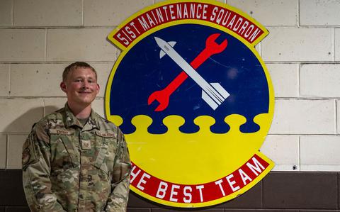 Photo Of U.S. Air Force Staff Sgt. Bryce Vincent, 51st Maintenance Squadron corrosion control lead, poses next to his shop’s emblem at Osan Air Base, Republic of Korea, July 31, 2025.