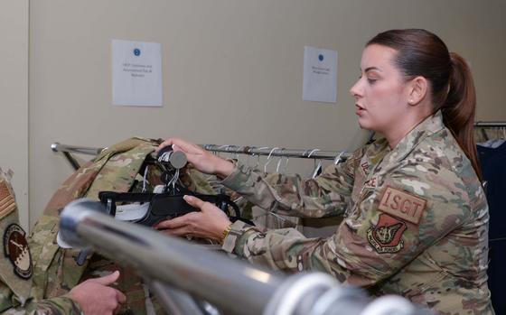 Master Sgt. Emily Dejesus, 51st Civil Engineer Squadron first sergeant, searches through clothing.