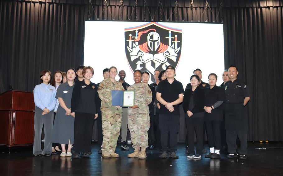 Osan Officers’ Club group photo as Stars and Stripes Commander Lt. Col. Marci Hoffman presents Best Sunday brunch award to Osan Officers’ Club staff.