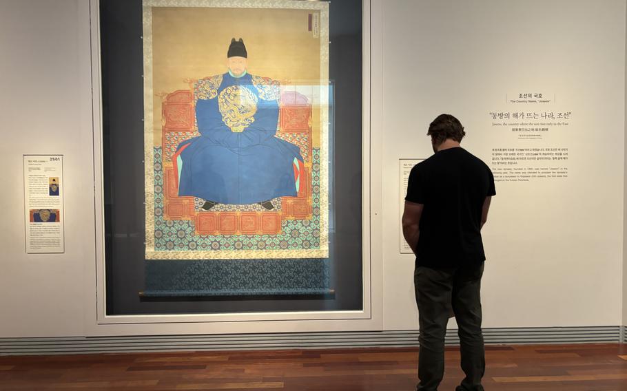 a visitor seeing a painting.