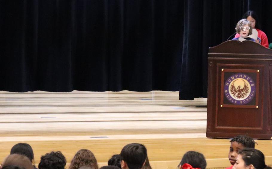 Master of Ceremony 6th grade student Bill Spoelman introducing special guest from General Crimes Team One and Two at the Far East Field Office Criminal Investigating Division (CID) at Camp Humphreys.