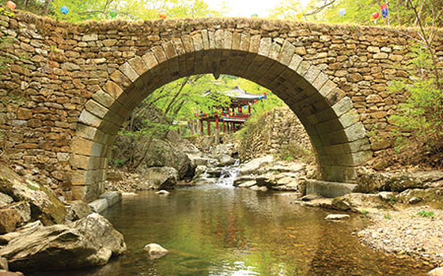 A bridge under a small stream inside the temple.