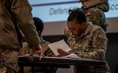 Photo Of U.S. Air Force Senior Airman Gianna Gress-Gomez simulates in-processing a 51st Fighter Wing member.