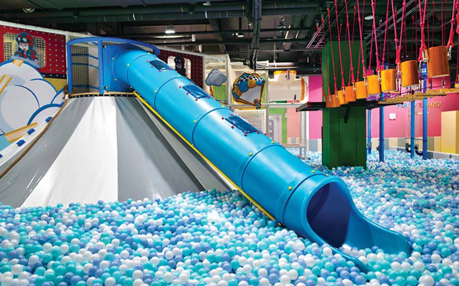 one of the attactions in the theme park. a slider and an abundance of plastic balls can be seen.