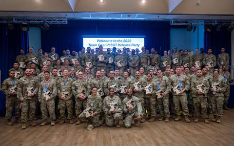 Photo Of The newest master sergeant selects pose for a group photo.