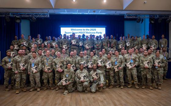 The newest master sergeant selects pose for a group photo.