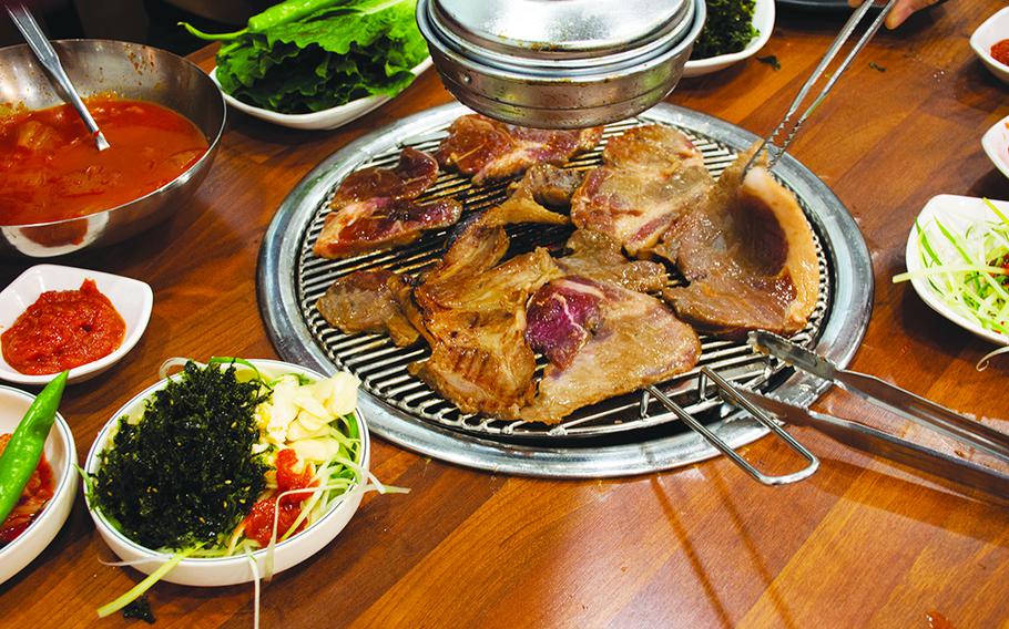 Local traditional korean gourmet food black pig of Jeju Island for grilled roasted barbecue pork and seasoning side dish for korean people taste eat drinks cuisine in local restaurant at South Korea.