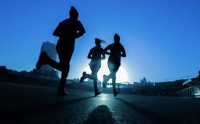 Three people are jogging.