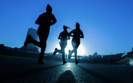 Three people are jogging.