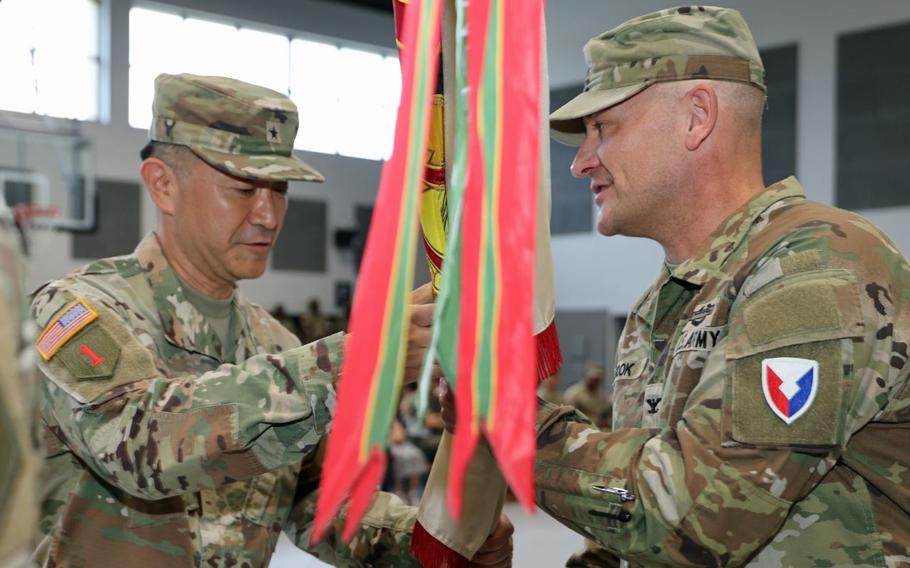 Brig. Gen. Jin Pak passes the unit colors to Col. Jason Book.