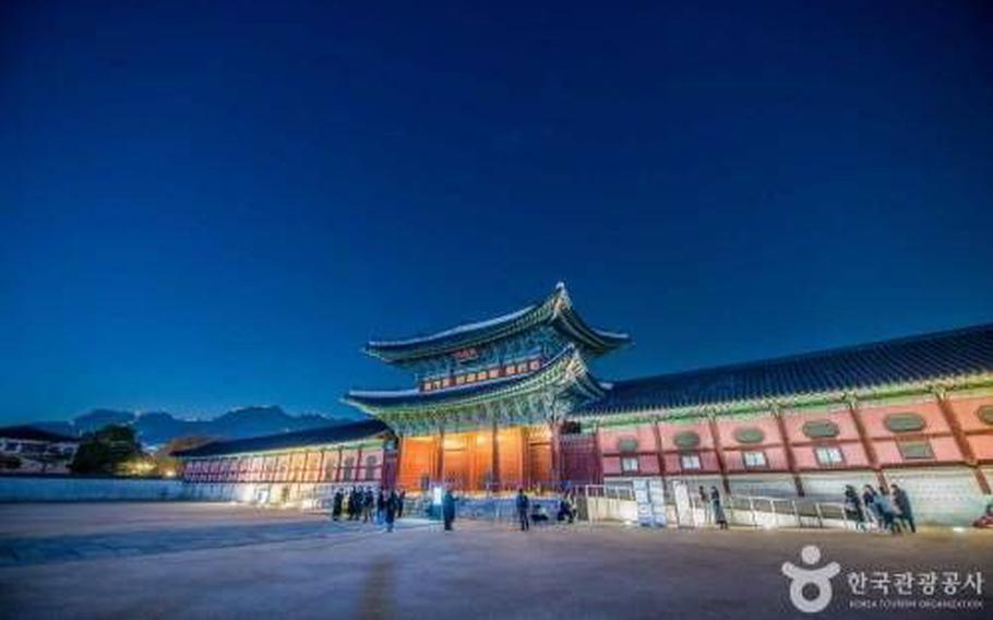 Gyeongbokgung Palace lights up at night.