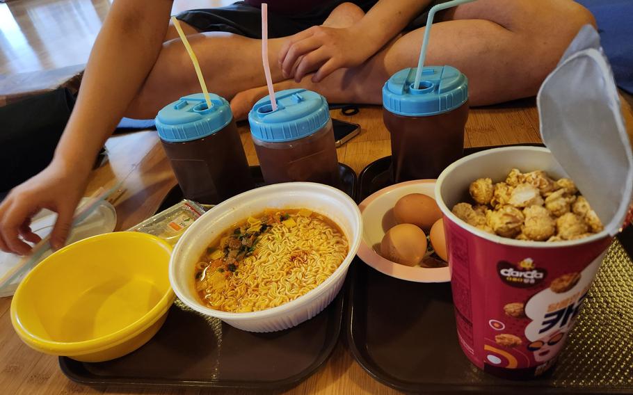 there are some traditional cold drinks and food on trays.